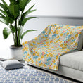 Load image into Gallery viewer, Floral-patterned blanket on a sofa with a plant and rug in the background