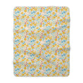 Load image into Gallery viewer, Floral patterned blanket with yellow, blue, and red flowers on a white background