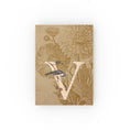 Load image into Gallery viewer, A vintage-style hard-backed journal with a monogram letter 'V' design, featuring floral patterns and a bird illustration.