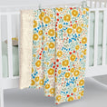 Load image into Gallery viewer, Floral patterned baby blankets draped over a crib