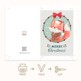 Load image into Gallery viewer, A Christmas greeting card design shown as a flat layout with fold and cut guides, featuring an illustrated fox in a red Santa hat and scarf inside a wreath, with 'Merry Christmas' text. Below the card are icons and labels for print, fold, and cut.