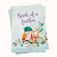 Load image into Gallery viewer, Card with two owls wearing a hat and scarf on a branch with flowers and 'Birds of a Feather' text.