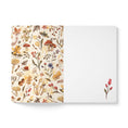 Load image into Gallery viewer, A notebook or journal shown open against a white background. The left page has a cream-colored cover decorated with a dense watercolor-style botanical and mushroom pattern in muted earthy tones.
