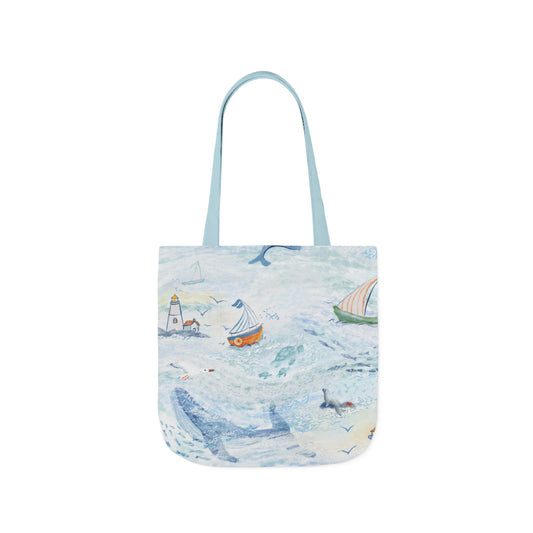 Tote bag with a coastal design featuring boats and a lighthouse on a white background