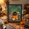 Load image into Gallery viewer, A framed autumn-themed painting of a black cat in an orange pumpkin, displayed on a table surrounded by pumpkins, candles, dried grass, and fall decorations.

