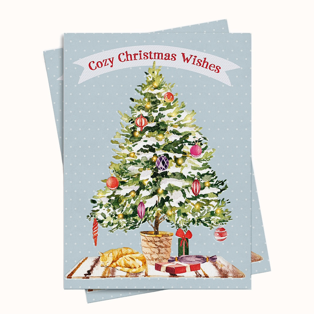 Christmas card with a decorated tree and 'Cozy Christmas Wishes' text on a light blue background.