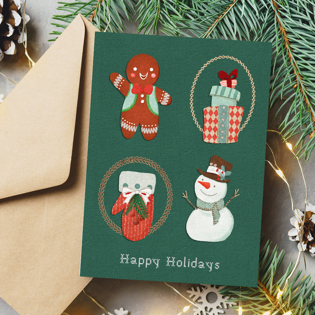 A dark green Christmas greeting card with four festive illustrations (gingerbread man, wrapped gifts, Santa in a red sweater, snowman) and the text 'Happy Holidays' at the bottom, styled with a kraft envelope, pine branches, and warm fairy lights.