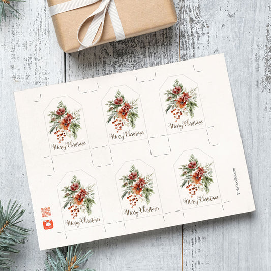 Printable Sheet of Christmas gift tags with floral designs on a wooden surface with a wrapped gift.