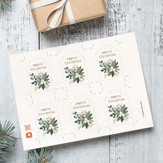 Printable DIY Sheet of Christmas gift tags with floral designs on a wooden surface.