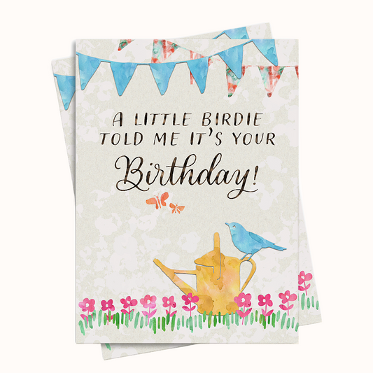 Greeting card with a watercolor design of a bird, watering can, and flowers, featuring the text 'A little birdie told me it's your Birthday!'.