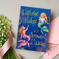 Load image into Gallery viewer, Greeting card with mermaid design and 'Birthday Wishes and Mermaid Kisses' text on a light background.

