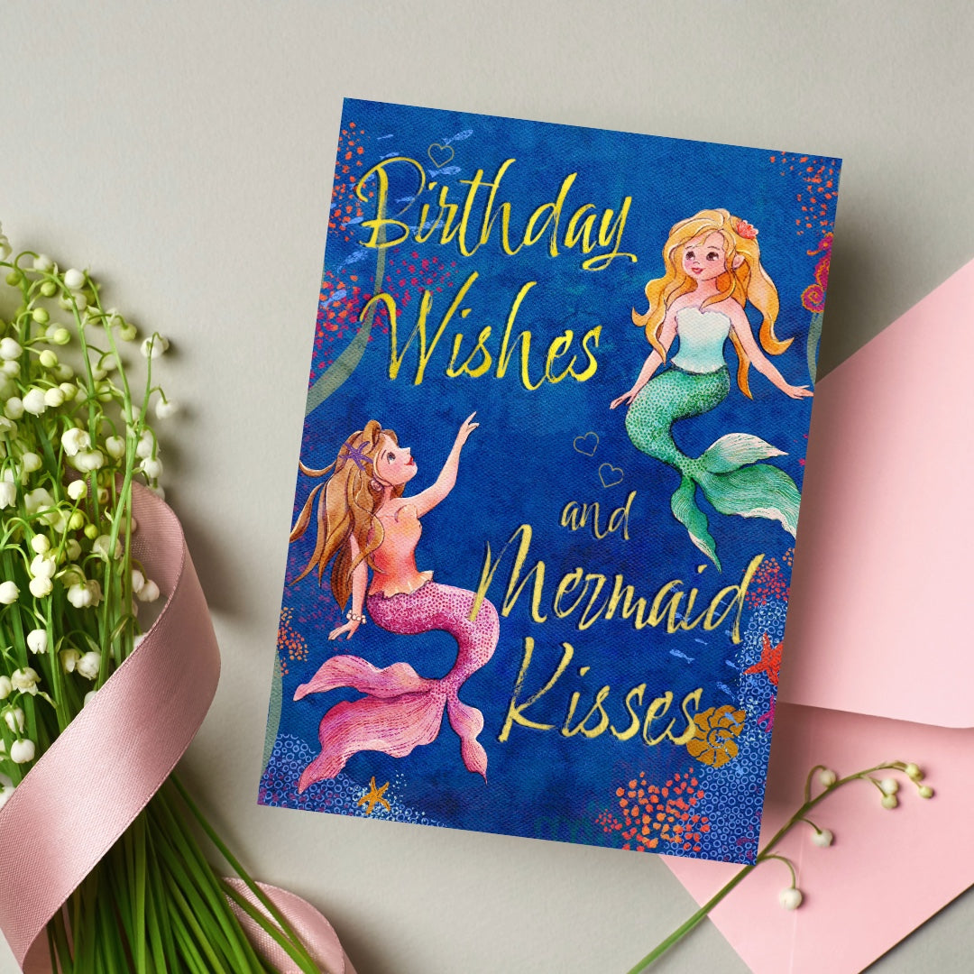 Greeting card with mermaid design and 'Birthday Wishes and Mermaid Kisses' text on a light background.