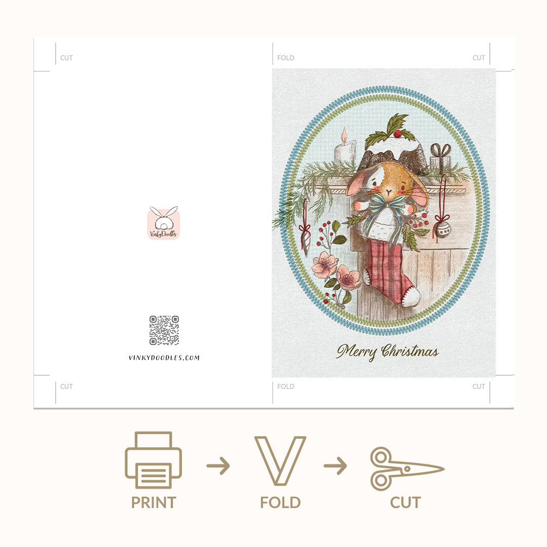 A Christmas-themed paper craft kit shown as an unfolded template with a printed front panel featuring a rabbit in a red stocking and the words 'Merry Christmas,' plus folding and cutting guide marks. Below the template are printed icons and text reading PRINT, FOLD, and CUT, indicating the assembly steps.