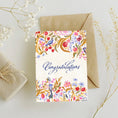 Load image into Gallery viewer, Greeting card with floral design and 'Congratulations' text, accompanied by a brown envelope and gift box on a light background.
